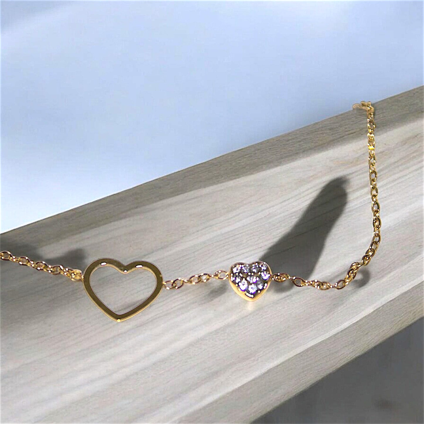 Classy pendant for a heart bracelet designed of high-quality, waterproof stainless steel, gold-plated. The pendant features two hearts: a large open heart and a smaller heart adorned with sparkling crystals. Perfect for every moment, water-resistant jewelry that is both fashionable and practical.